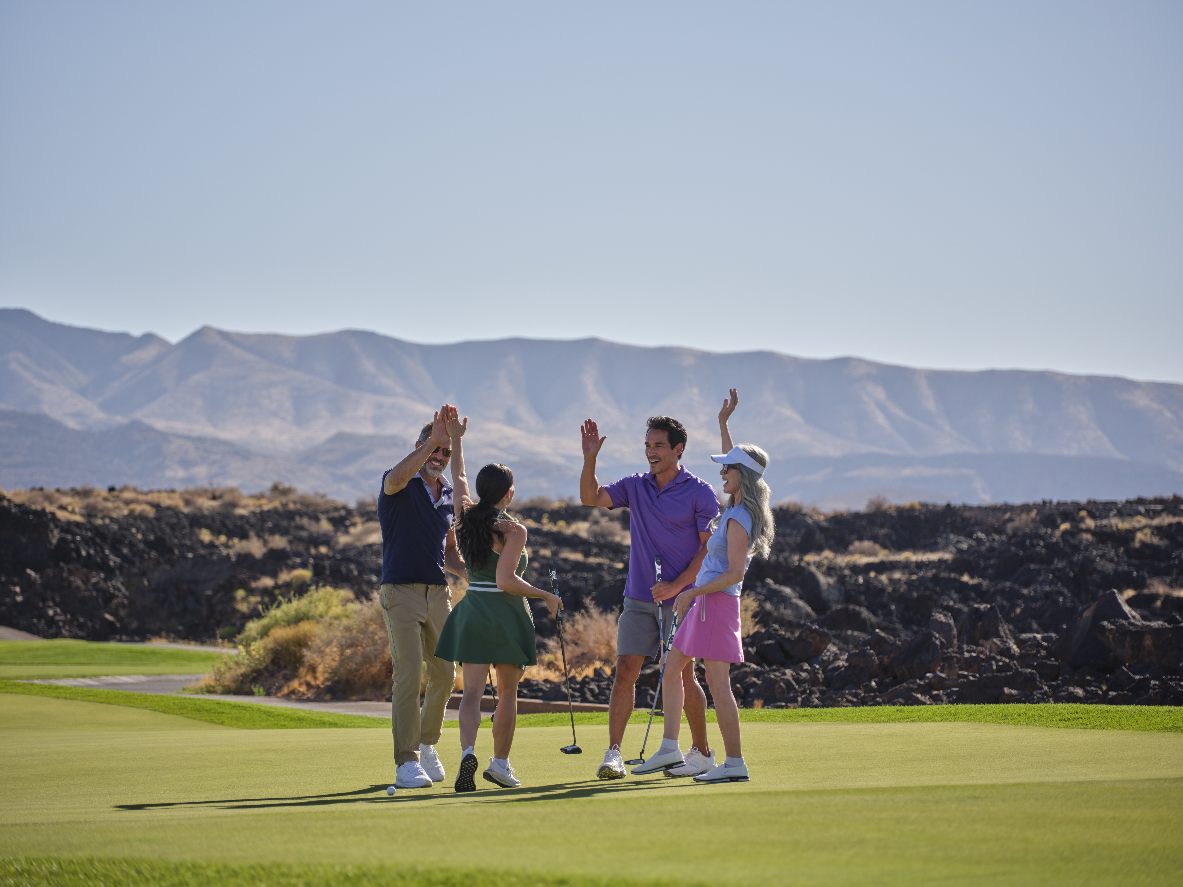 Golfer on Black Desert Resort course with dramatic lava field landscape