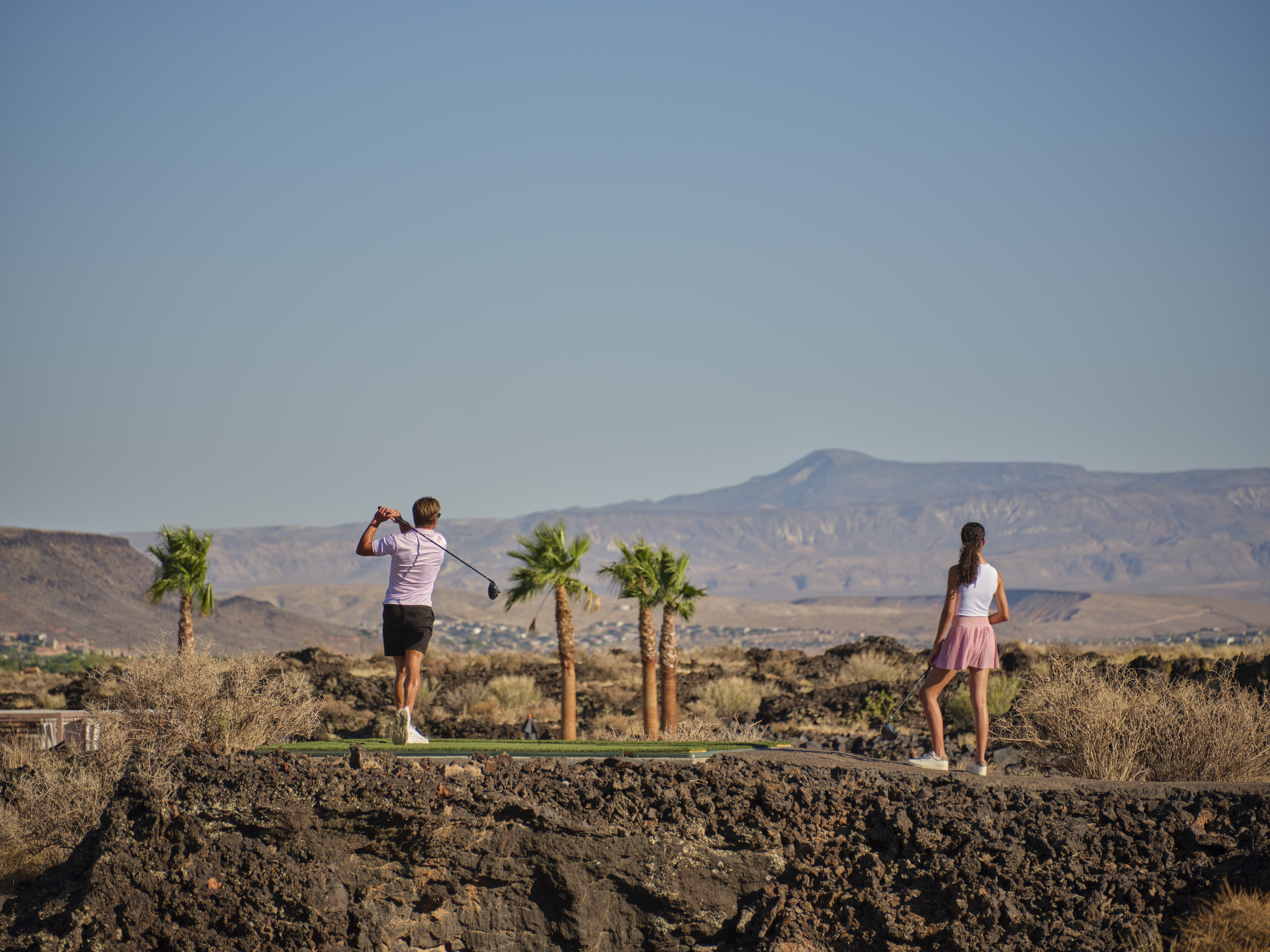 Black Desert Resort green with red cliff views and lava rock framing